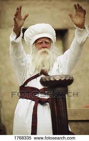 Stock Photography - Priest with arms outstretched. Fotosearch