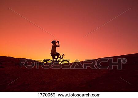 Silhouette person on bike View Large Photo Image Stock Photo - Silhouette person on bike. Fotosearch