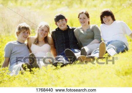 Teenagers sitting in field View Large Photo Image Stock Image - Teenagers sitting in field. Fotosearch