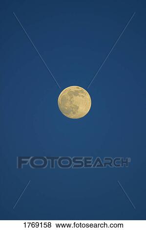 Stock Photo - The moon in the night's sky. Fotosearch
