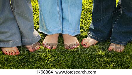 Three pairs of bare feet View Large Photo Image Picture - Three pairs of bare feet. Fotosearch
