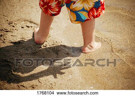 Picture - Toddler feet in sand at beach. Fotosearch