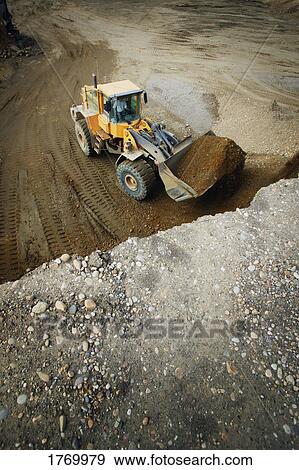 Tractor moving dirt View Large Photo Image Stock Photo - Tractor moving dirt. Fotosearch