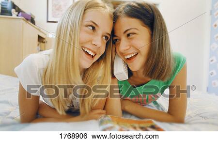 Stock Photograph - Two girls on the phone. Fotosearch