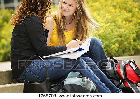 Two girls work together on school work View Large Photo Image Stock Photo - Two girls work together on school work. Fotosearch