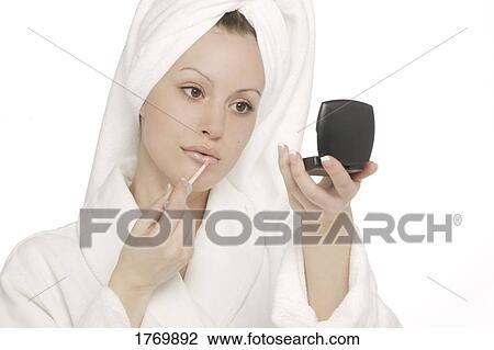 Woman applying lip-gloss View Large Photo Image Stock Image - Woman applying lip-gloss. Fotosearch