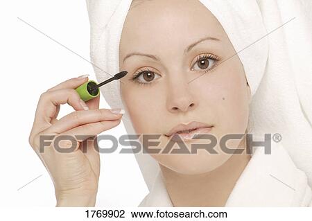 Woman applying makeup View Large Photo Image Stock Image - Woman applying makeup. Fotosearch
