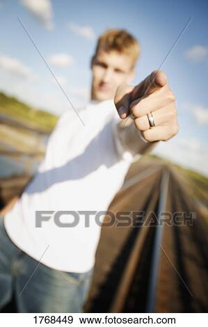 Stock Photo - young man pointing. Fotosearch