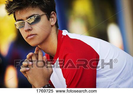 Young man wearing trendy sunglasses View Large Photo Image Stock Photography - Young man wearing trendy sunglasses. Fotosearch