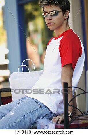 Stock Image - A teenager with sunglasses. Fotosearch