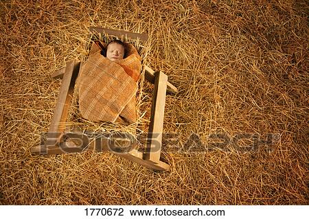 Baby Jesus lying in a manger View Large Photo Image Stock Image - Baby Jesus lying in a manger. Fotosearch