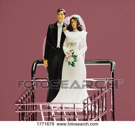 Stock Photo - Bride and groom ornament in shopping cart. Fotosearch