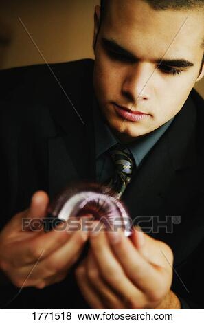 Stock Photo - Businessman playing with spring toy. Fotosearch