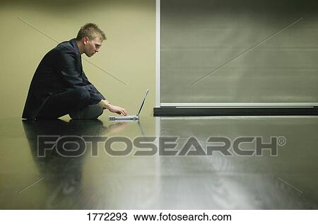 Businessman working on laptop View Large Photo Image Stock Image - Businessman working on laptop. Fotosearch