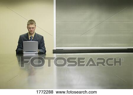 Stock Photo - Businessman working on laptop. Fotosearch