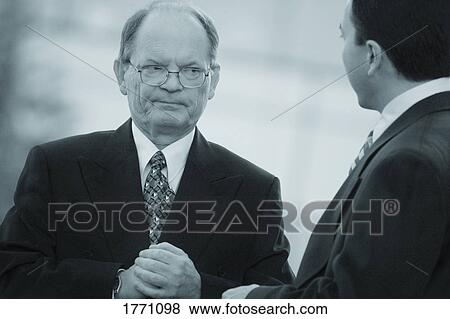 Businessmen in serious discussion View Large Photo Image Stock Photo - Businessmen in serious discussion. Fotosearch