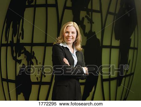 Stock Photography - Businesswoman in front of world map. Fotosearch