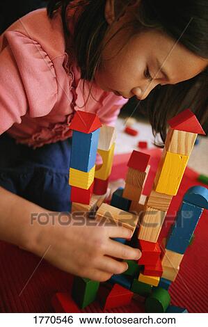 Stock Photograph - Child playing with building blocks. Fotosearch