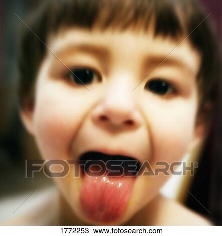 Stock Image - Child sticking their tongue out. Fotosearch