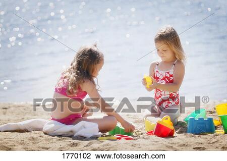 Stock Image - Children play at the beach. Fotosearch