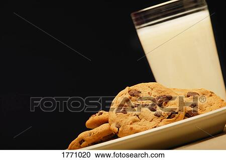 Stock Image - Cookies and glass of milk. Fotosearch