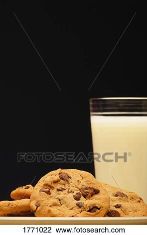 Stock Image - Cookies and glass of milk. Fotosearch