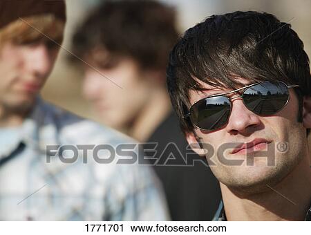 Stock Image - Cool young man with sunglasses. Fotosearch