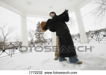 Stock Image - Couple dancing in snow. Fotosearch