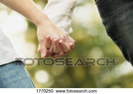 Stock Image - Couple holding hands. Fotosearch