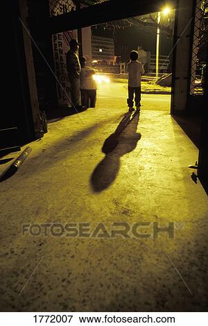 Ethnic man and boy at night View Large Photo Image Stock Photo - Ethnic man and boy at night. Fotosearch