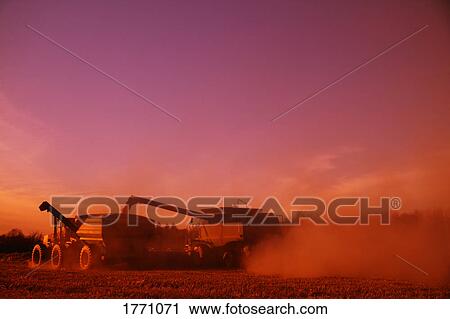 Stock Image - Farm equipment harvesting a crop. Fotosearch