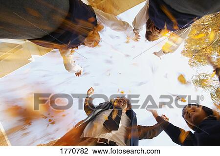 Stock Image - Group of students reaching for sky. Fotosearch