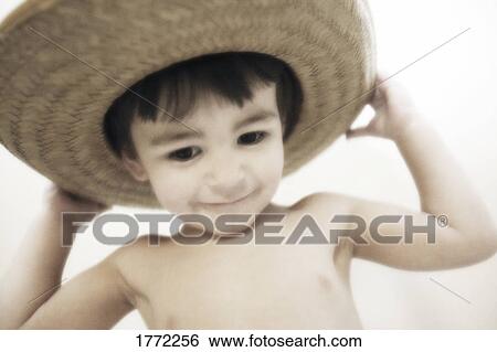 Little child playing with hat View Large Photo Image Stock Photograph - Little child playing with hat. Fotosearch