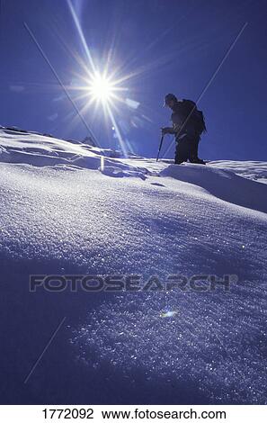 Lone mountaineer walking on snow View Large Photo Image Stock Image - Lone mountaineer walking on snow. Fotosearch