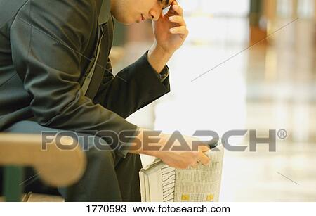 Stock Image - Man reading newspaper. Fotosearch