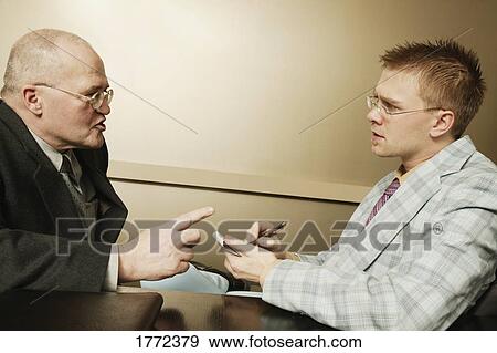 Man telling junior professional what to do View Large Photo Image Stock Photo - Man telling junior professional what to do. Fotosearch