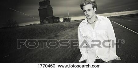 Man walking along road View Large Photo Image Stock Image - Man walking along road. Fotosearch