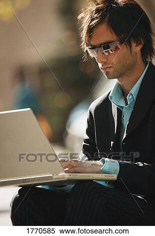 Man working on computer View Large Photo Image Stock Photography - Man working on computer. Fotosearch