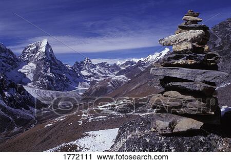 Mountainous terrain with stone monument in foreground View Large Photo Image Stock Image - Mountainous terrain with stone monument in foreground. Fotosearch