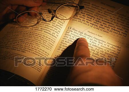 Stock Image - Open Bible and pair of spectacles. Fotosearch