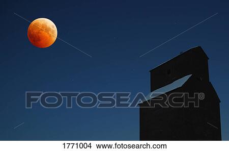Orange moon at night with grain elevator View Large Photo Image Picture - Orange moon at night with grain elevator. Fotosearch