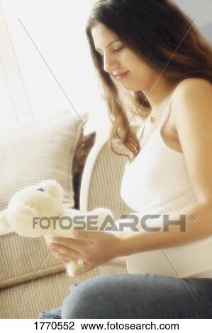 Pregnant Woman holding teddy bear View Large Photo Image Stock Image - Pregnant Woman holding teddy bear. Fotosearch