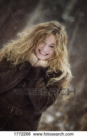 Stock Photograph - Pretty girl against wintry background. Fotosearch