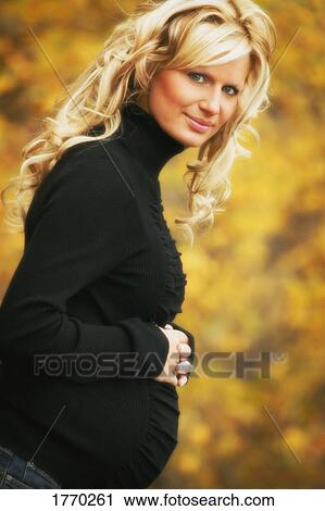 Stock Image - Profile of Pregnant woman. Fotosearch
