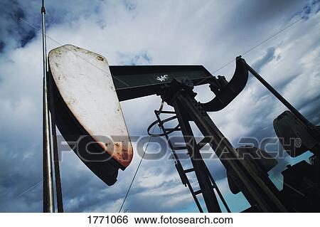 Pump jack pumping oil View Large Photo Image Stock Photograph - Pump jack pumping oil. Fotosearch