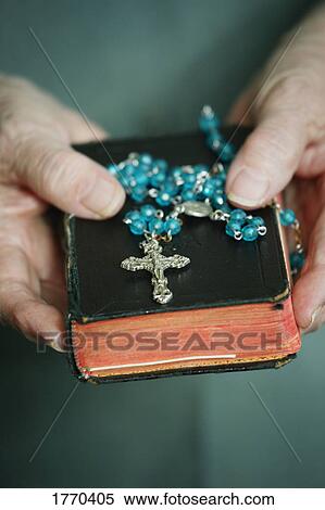 Rosary beads & bible held View Large Photo Image Stock Photography - Rosary beads & bible held. Fotosearch