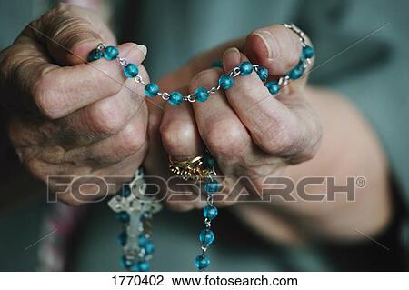 Rosary beads in hand View Large Photo Image Stock Image - Rosary beads in hand. Fotosearch