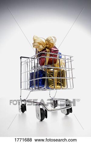 Stock Photo - Shopping trolley and gifts. Fotosearch