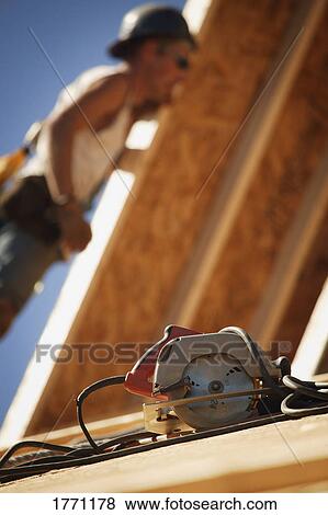 Skill saw on roof View Large Photo Image Stock Photo - Skill saw on roof. Fotosearch