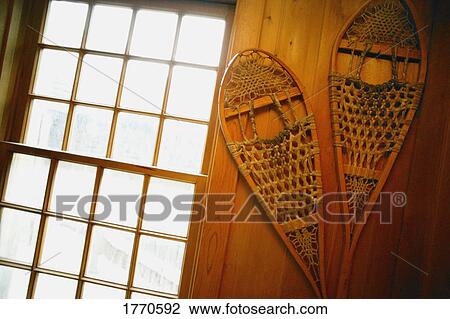 Stock Image - Snowshoes on wall. Fotosearch